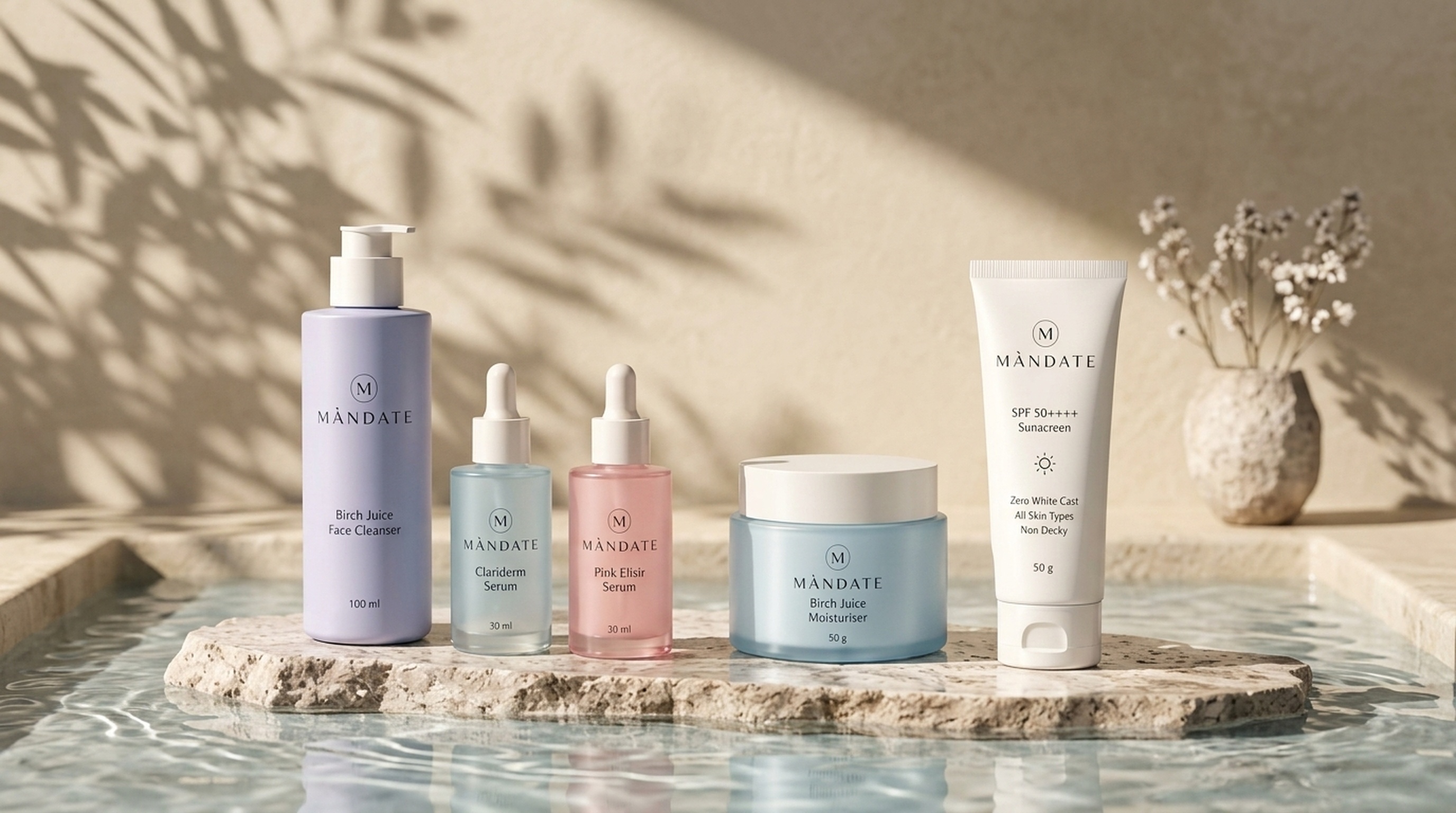 MÀNDATE 5 Essentials arranged on travertine limestone in tranquil water